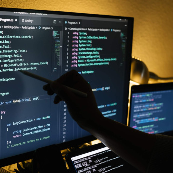 man working at night coding and pointing on a scre 2023 11 27 05 10
