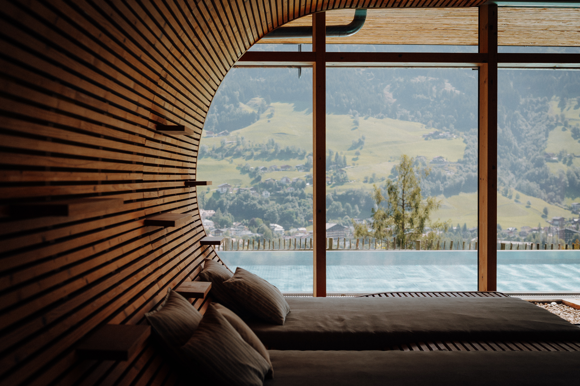 Panorama-Spa mit Innen- und Außenpool hoch über dem Tal im Luxus-Wellnesshotel DAS.GOLDBERG