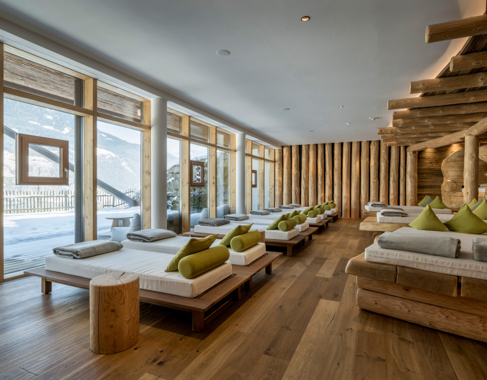 Infinity-Außenpool eines Luxus-Wellnesshotels mit Bergpanorama im Salzburger Land bei Sonnenuntergang