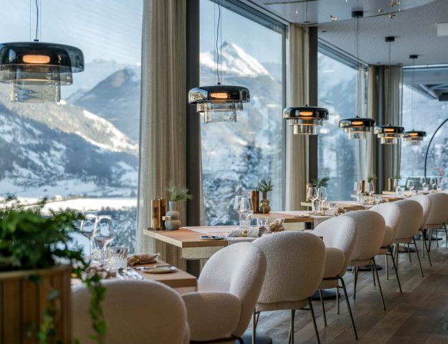 Modernes Restaurant mit Panoramafenstern und Blick auf die Alpen im Designhotel Bad Hofgastein