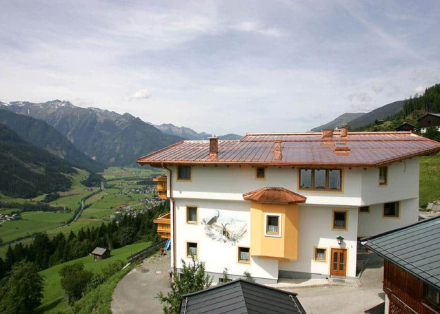 Alpengasthof mit Panoramablick auf grüne Täler und Berge der Hohen Tauern